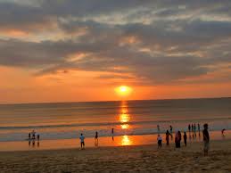 Jimbaran Beach at sunset, known for seafood dinners on the sand