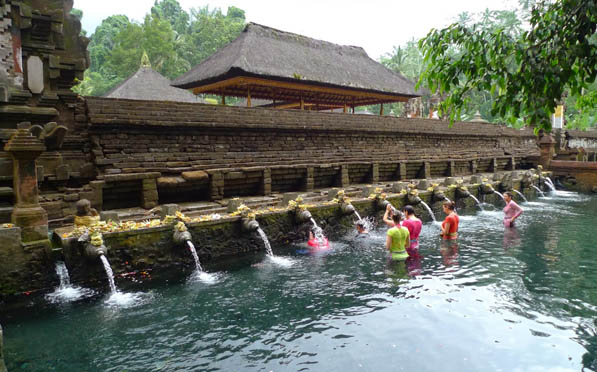 Guests performing the Melukat purification ritual at Tirta Empul holy spring